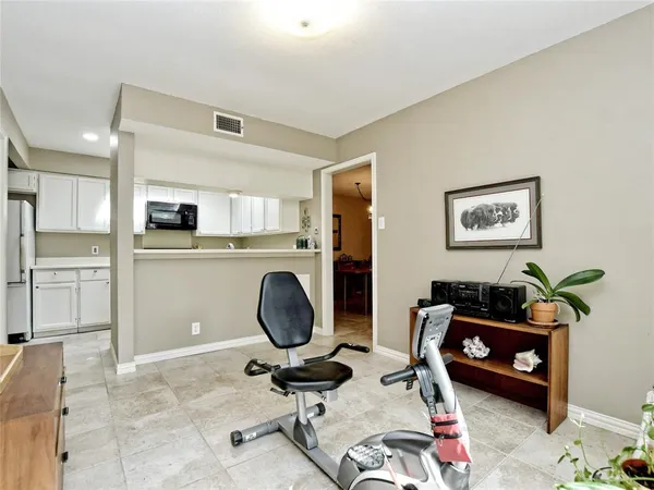 a room with furniture a rug and white walls