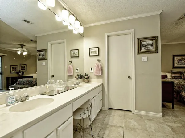 a bathroom with a double vanity sink and a mirror