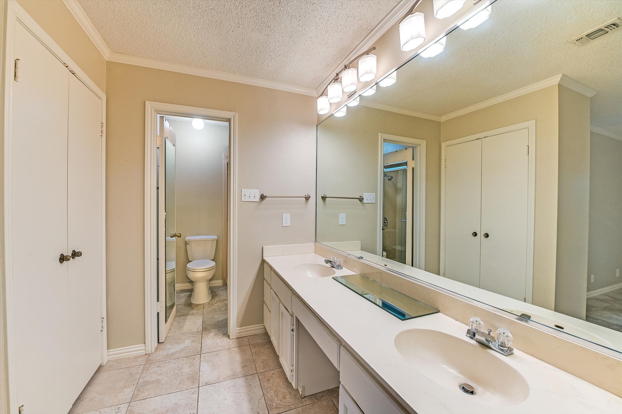 7919 Ridgeline North Austin, TX 78731 - Photo 17 of 23 a bathroom with a double vanity sink mirror and toilet