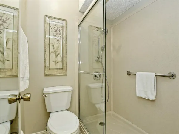 a white toilet sitting next to a bathroom sink