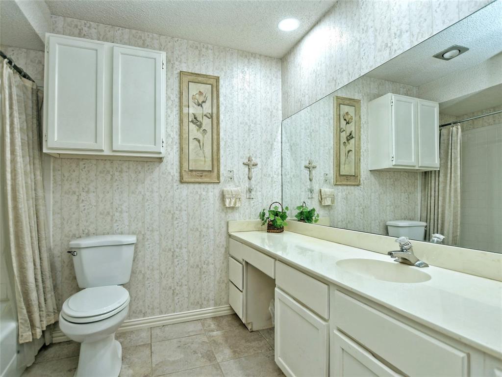 7919 Ridgeline North Austin, TX 78731 - Photo 21 of 23 a bathroom with a toilet sink and mirror