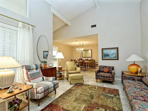 a living room with furniture and a chandelier