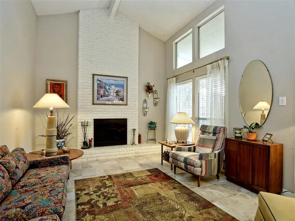 a living room with furniture large window and a fireplace