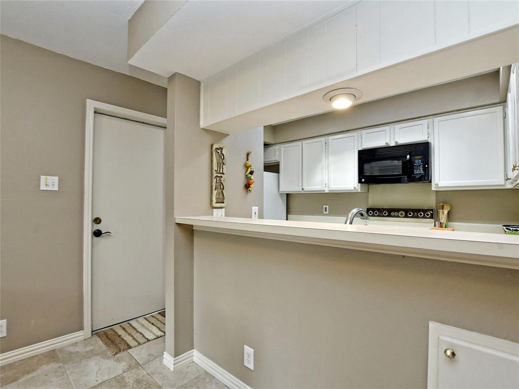 7919 Ridgeline North Austin, TX 78731 - Photo 10 of 23 a kitchen with stainless steel appliances a sink a stove a microwave a refrigerator and cabinets