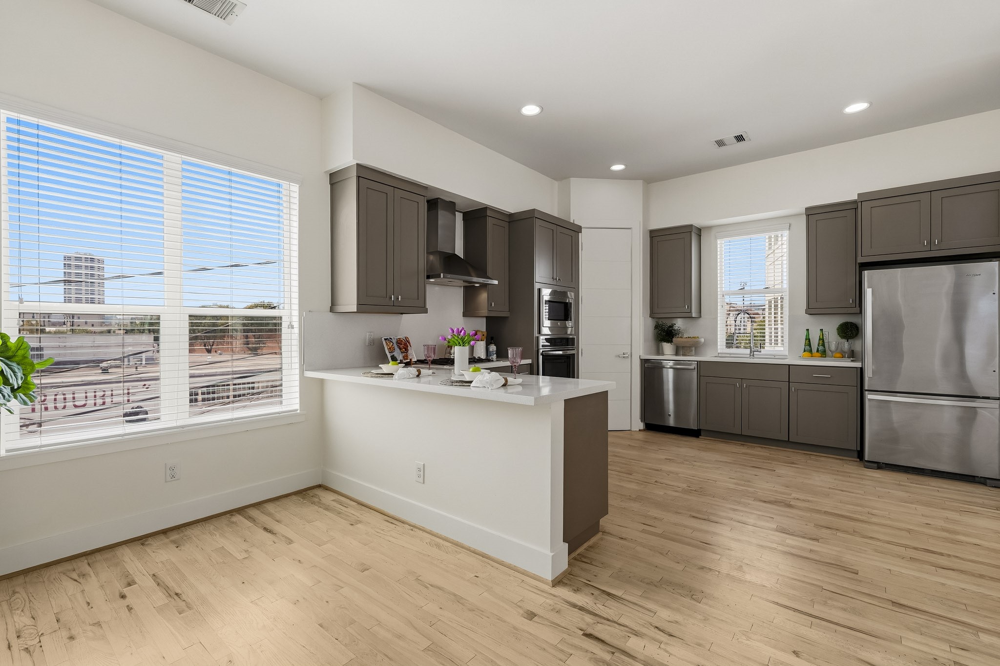 2004 Rosedale Street, Unit D Houston, TX 77004 - Photo 20 of 45 A deep pot-and-pan drawer beneath the oven keeps cookware within easy reach, while hardwood floors extend through the kitchen and breakfast room for a warm, cohesive finish.