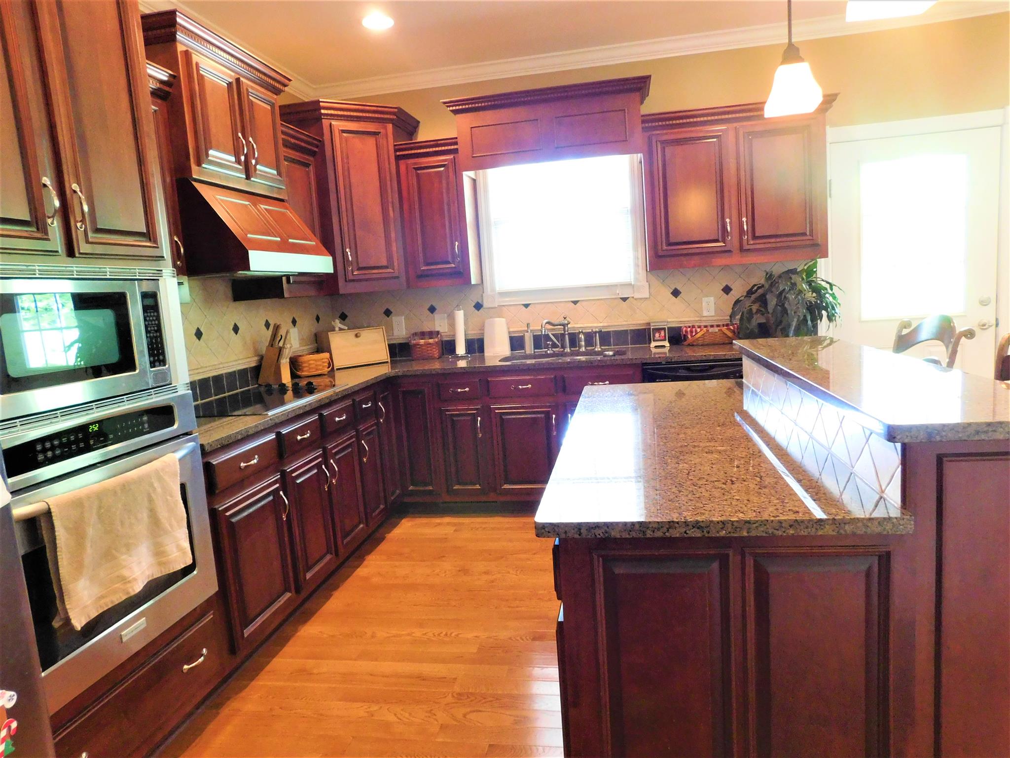 3539 Old Rome Pike Lebanon, TN 37087 - Photo 18 of 30 Stainless appliances, granite, cooktop, B-I oven, and tile backsplash
