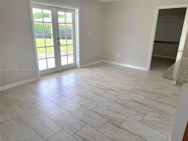 a view of a hallway with entryway door