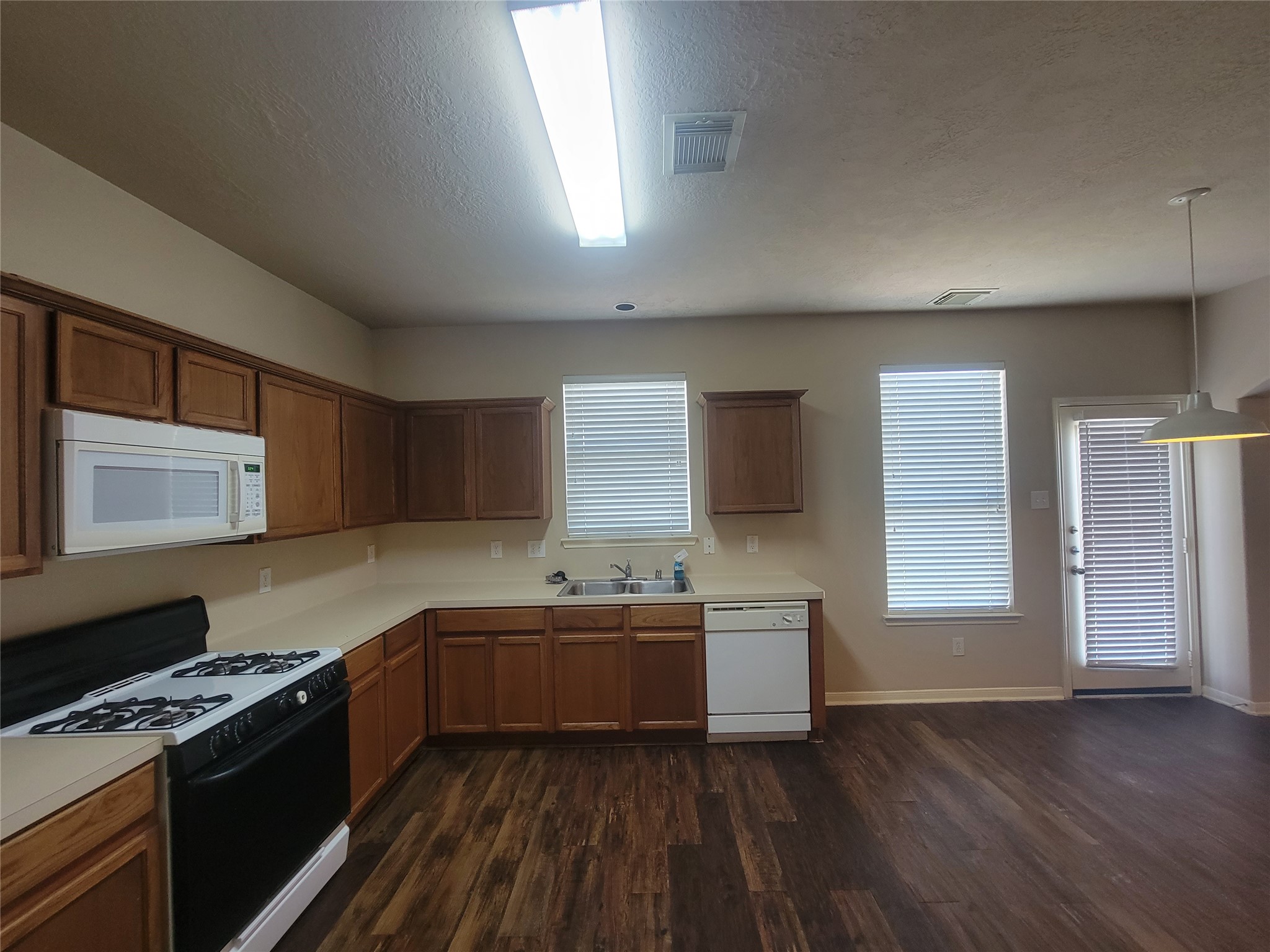 3110 Clover Ranch Circle Katy, TX 77494 - Photo 7 of 28 a kitchen with a sink stove top oven and cabinets