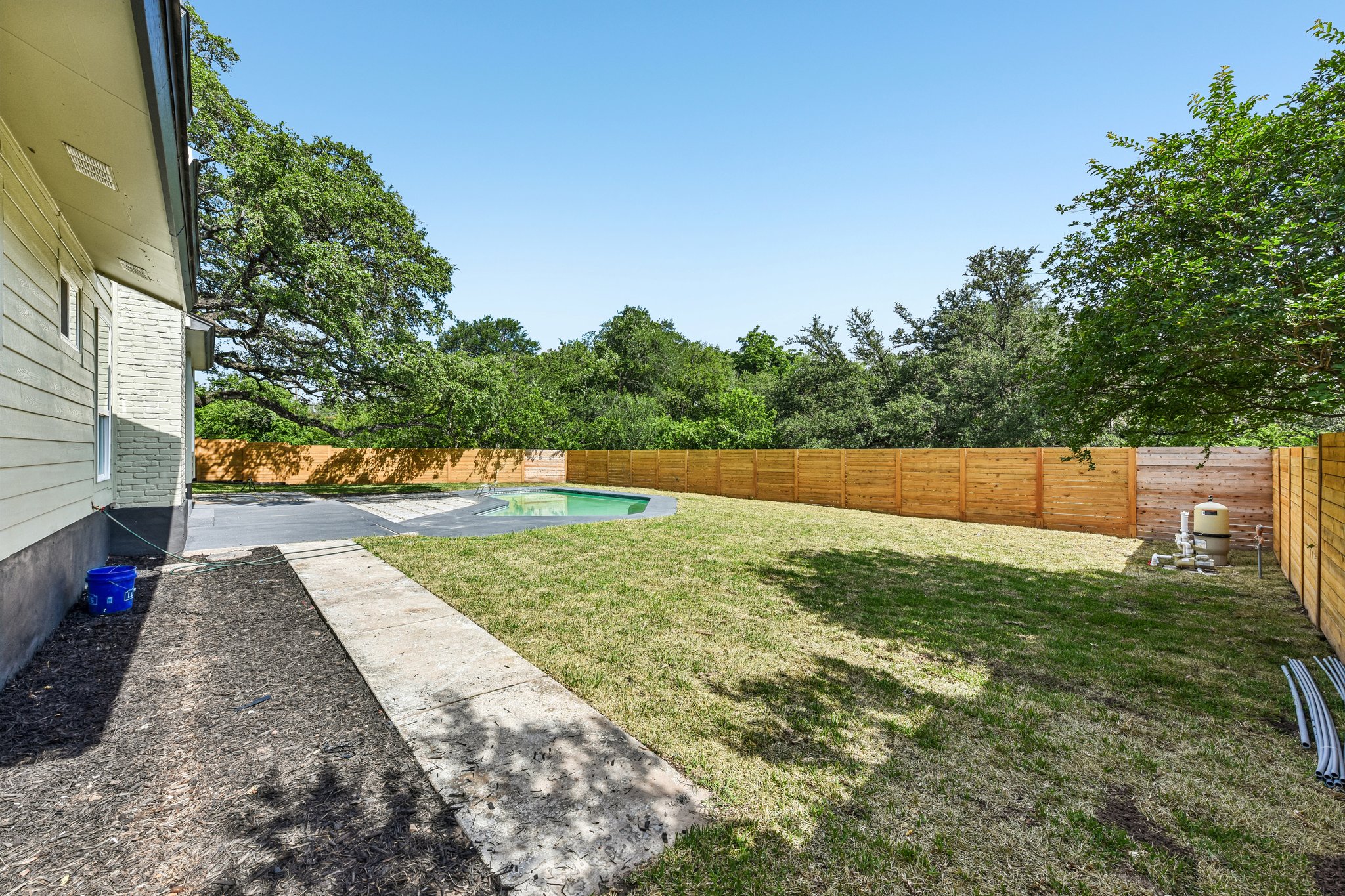 7523 Glenhill Road Austin, TX 78752 - Photo 34 of 38 A private outdoor sanctuary awaits, featuring a refreshing in-ground pool and ample green space for relaxation.