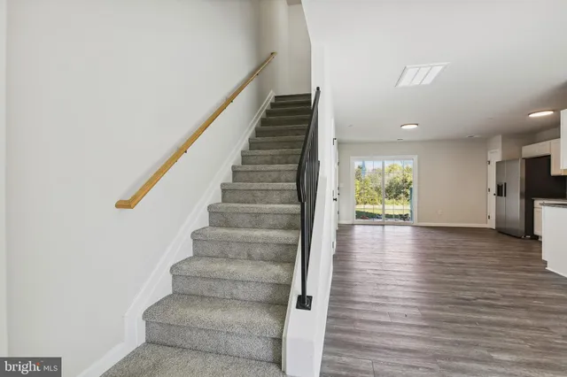 a view of entryway and hall with wooden floor