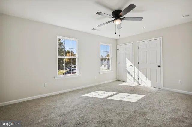 a view of empty room with ceiling fan