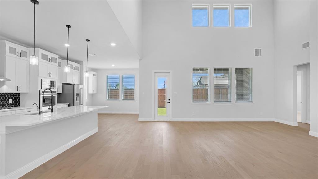 1608 Keneipp Road Carrollton, TX 75006 - Photo 2 of 13 a view of a kitchen with a sink hardwood floor and a window