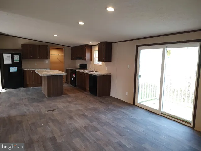 a large kitchen with a table and chairs