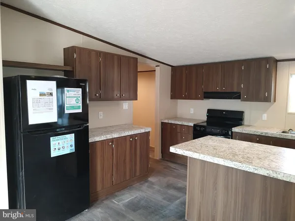 a kitchen with stainless steel appliances granite countertop wooden cabinets a sink and a stove