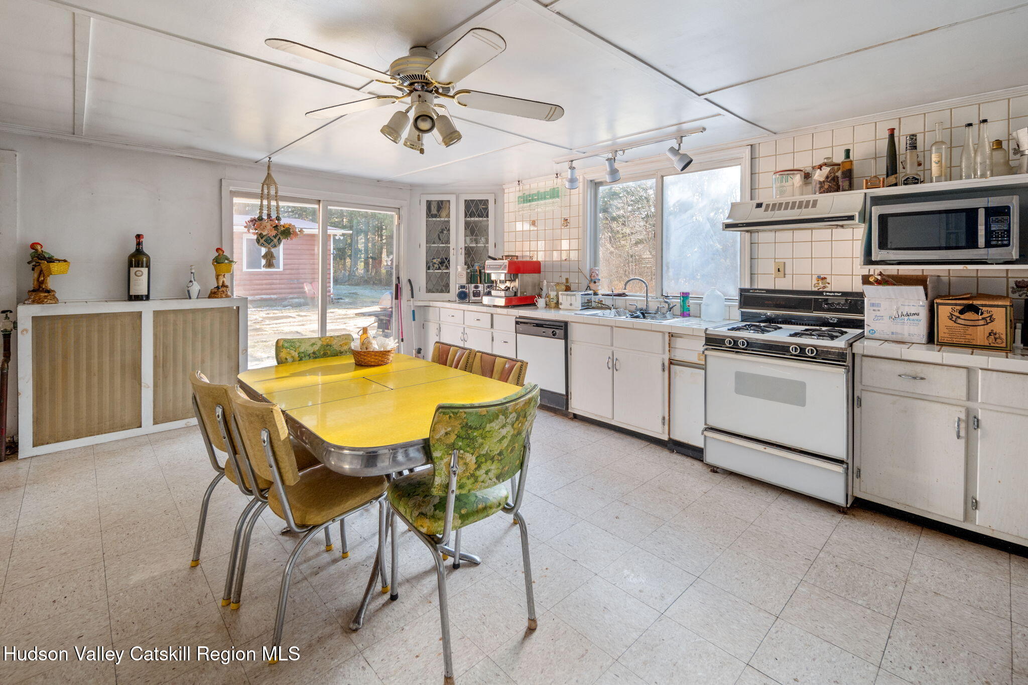 403 Blueberry Hill Road Middleburgh, NY 12122 - Photo 7 of 50 a kitchen with stainless steel appliances a table chairs and a refrigerator