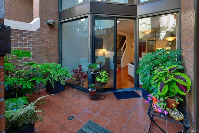 a vase of flowers sitting in front of a door