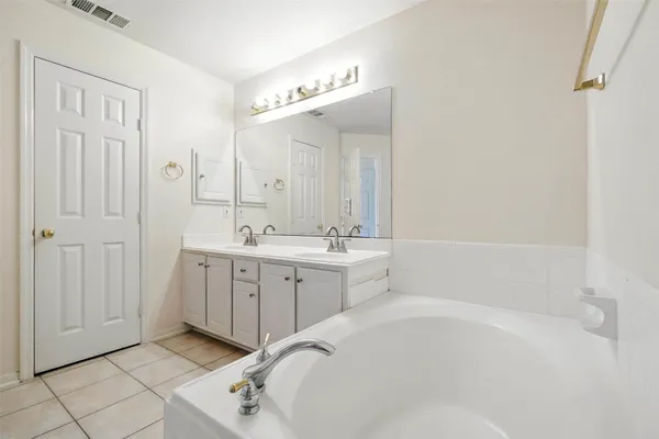 a bathroom with a sink a vanity and mirror