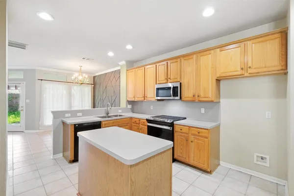 a kitchen with a sink stove and cabinets