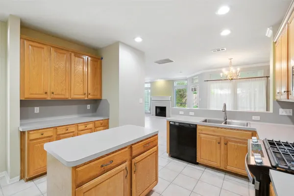 a kitchen with a table chairs microwave and cabinets