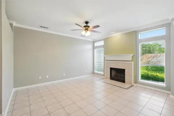 a view of an empty room with window and cabinet