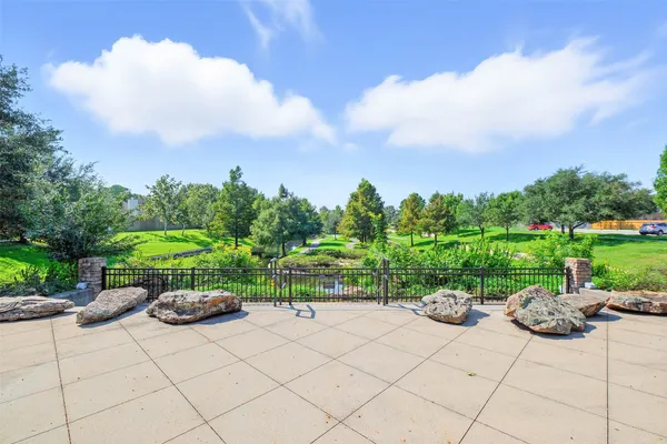 a view of backyard with outdoor seating and green space