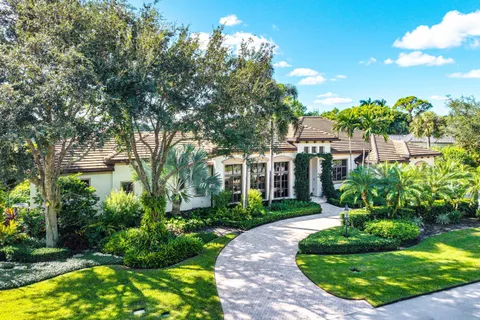 a front view of a house with a yard garage and outdoor seating