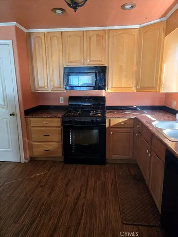 a kitchen with wooden floors and a sink