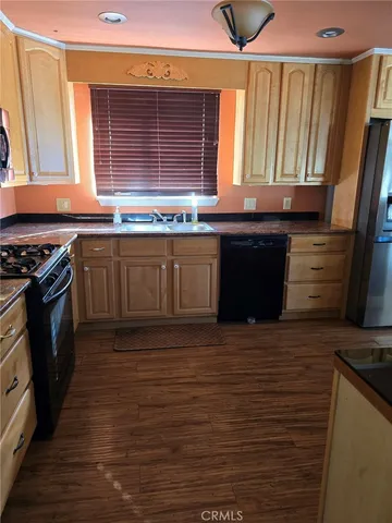 a kitchen with granite countertop a stove and a sink