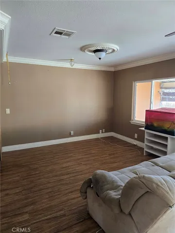 a room with a bed and a ceiling fan