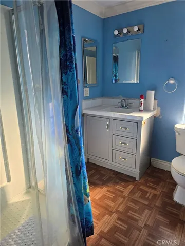 a bathroom with a sink a mirror and a toilet