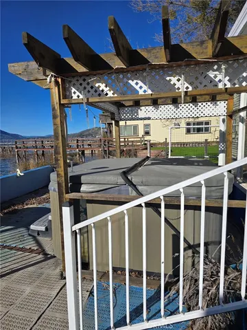 a view of a patio with table and chairs with wooden floor and fence