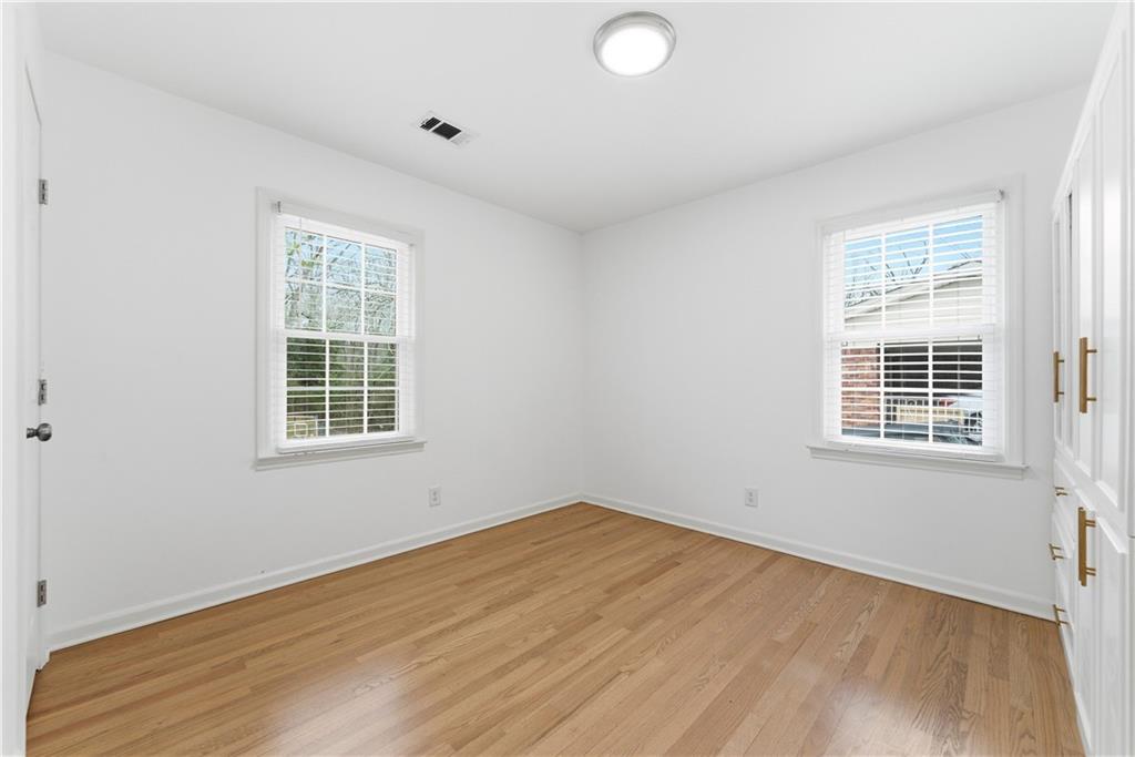 2975 Nursery Road Southeast Smyrna, GA 30082 - Photo 13 of 36 an empty room with wooden floor and windows
