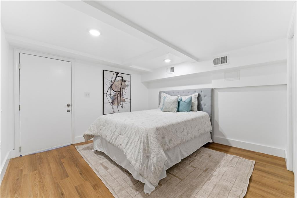 2975 Nursery Road Southeast Smyrna, GA 30082 - Photo 17 of 36 a bedroom with a bed and wooden floor