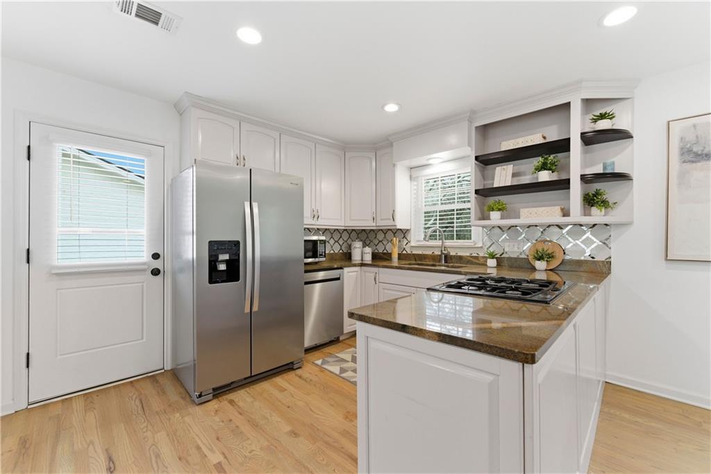 2975 Nursery Road Southeast Smyrna, GA 30082 - Photo 5 of 36 a kitchen with granite countertop a refrigerator and a sink