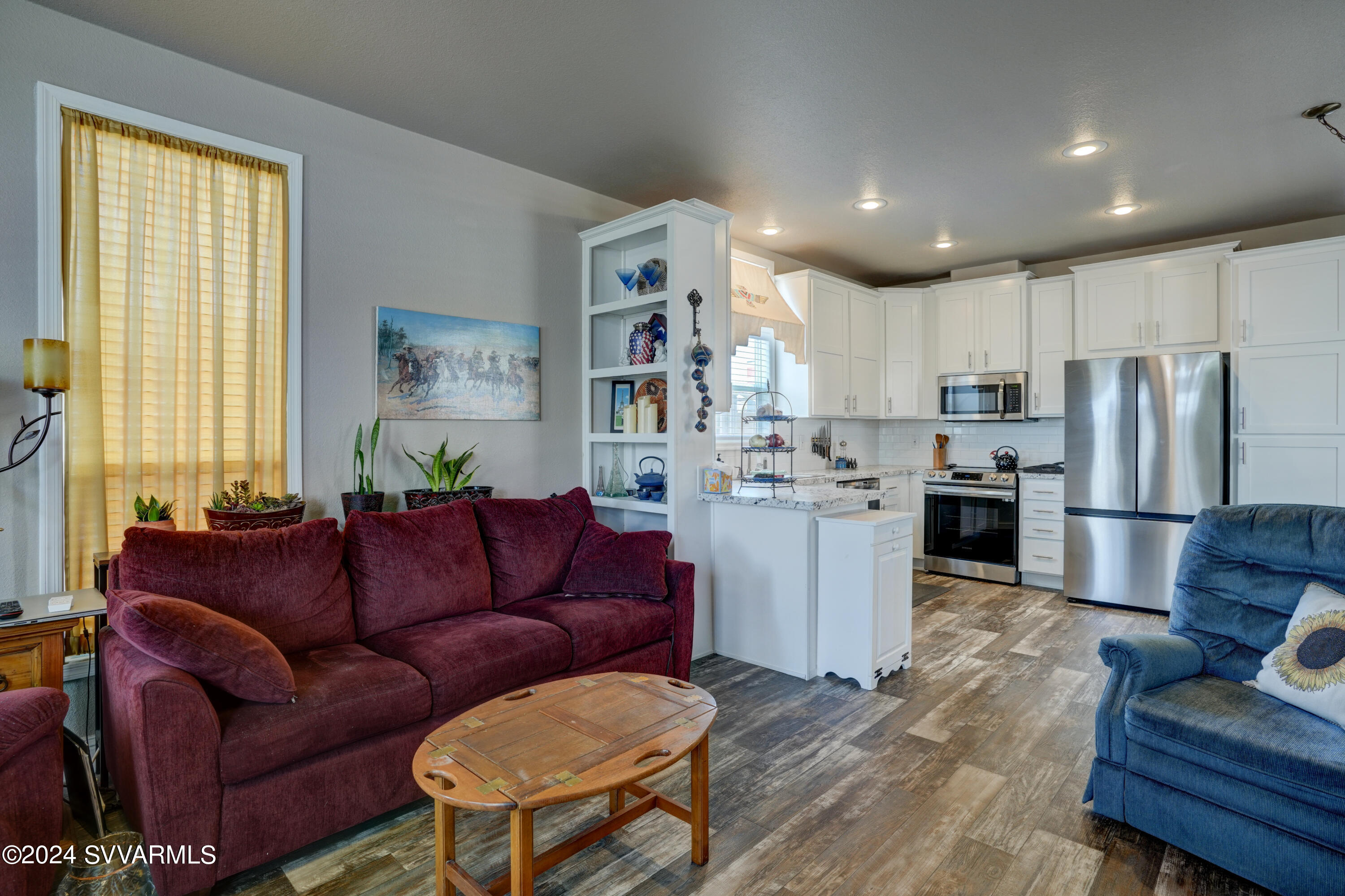999 Thorton Road, Unit 21 Camp Verde, AZ 86322 - Photo 11 of 23 a living room with stainless steel appliances kitchen island furniture and a large window
