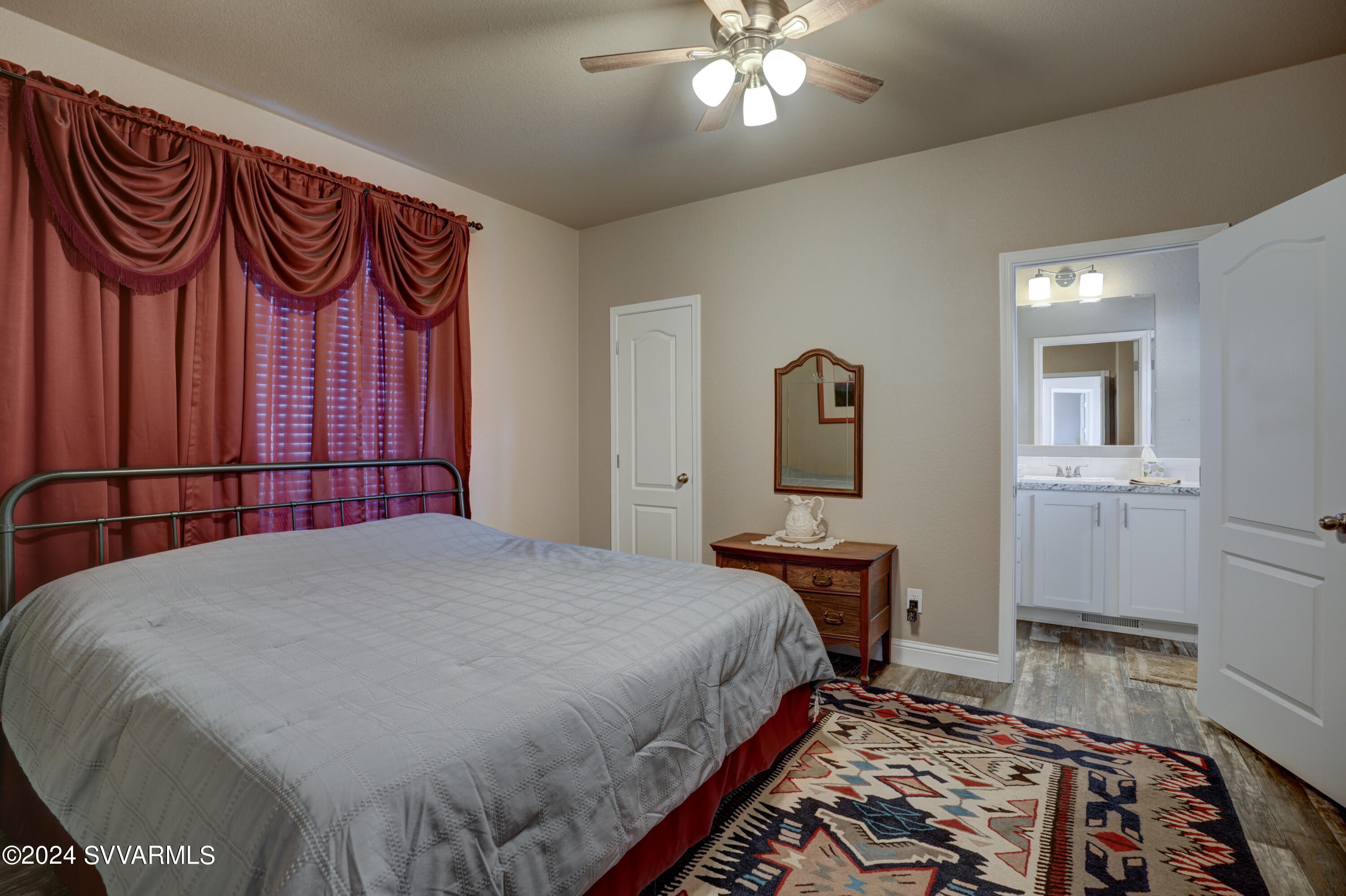 999 Thorton Road, Unit 21 Camp Verde, AZ 86322 - Photo 16 of 23 a bedroom with a bed and dresser with mirror