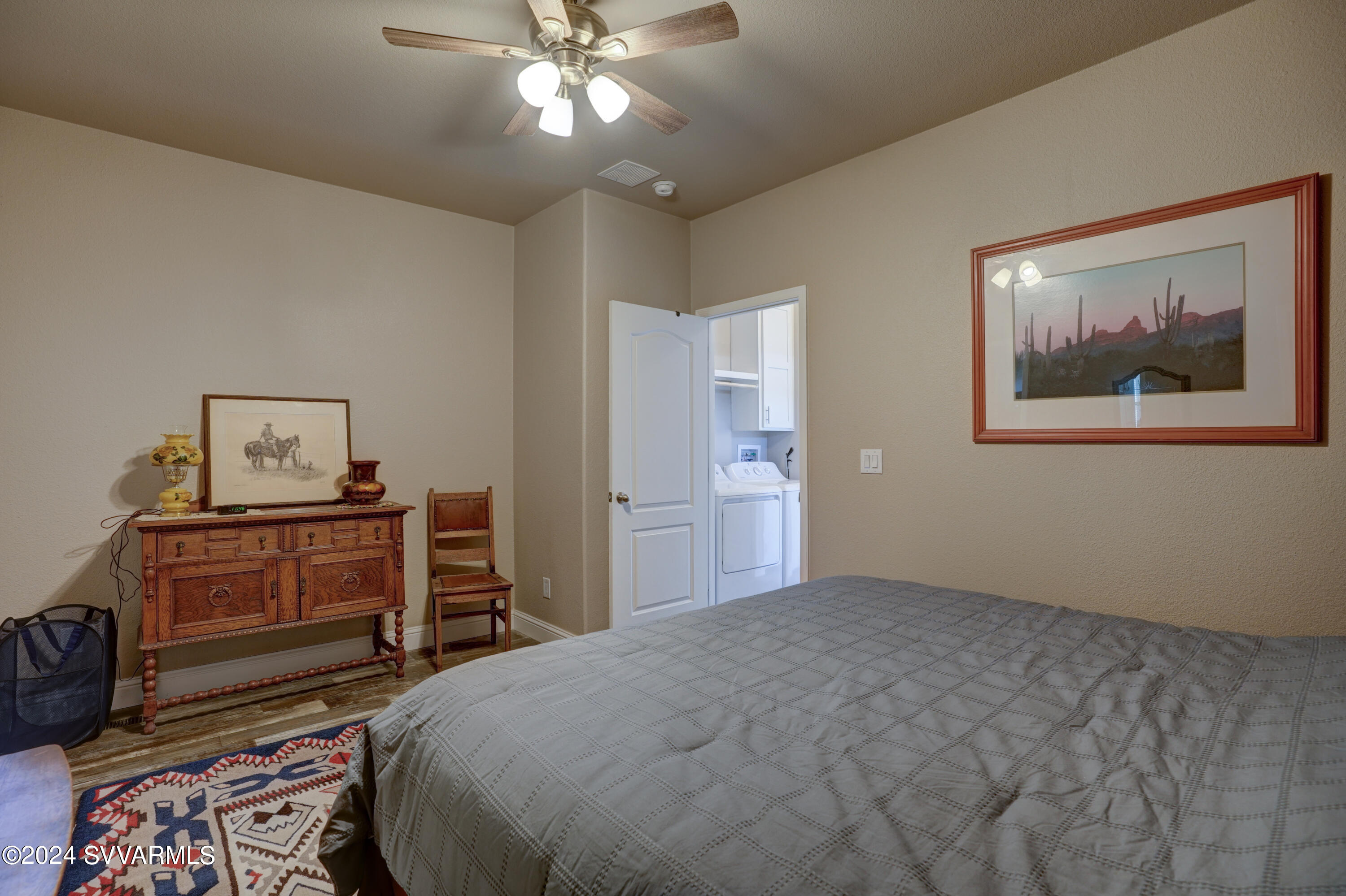 999 Thorton Road, Unit 21 Camp Verde, AZ 86322 - Photo 17 of 23 a bedroom with a bed and a chandelier