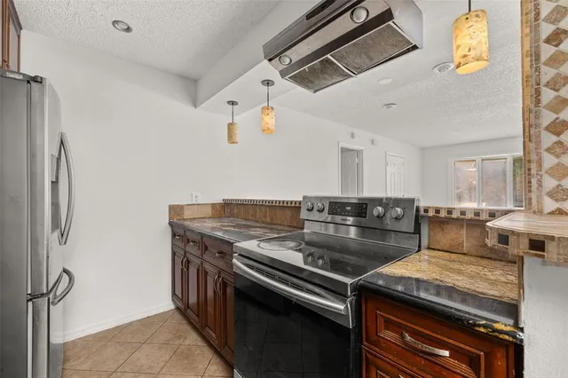 a kitchen with a stove and a refrigerator
