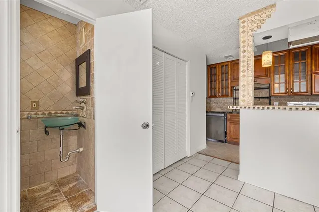 a kitchen with stainless steel appliances granite countertop a refrigerator and a stove