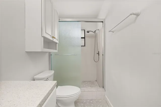a bathroom with a toilet and a shower