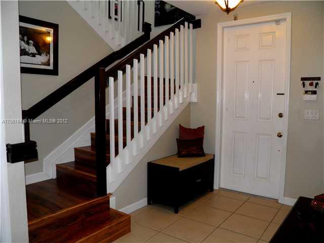 9237 Southwest 227th Street, Unit 12 Cutler Bay, FL 33190 - Photo 2 of 9 a view of entryway and hall with wooden floor