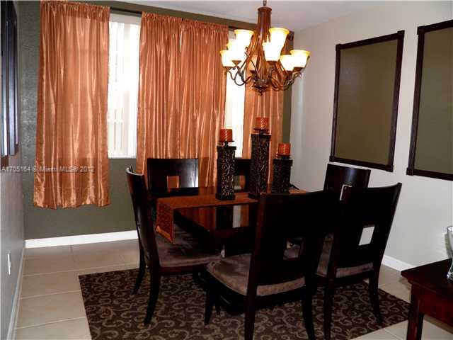 9237 Southwest 227th Street, Unit 12 Cutler Bay, FL 33190 - Photo 4 of 9 a view of a dining room with furniture and a window