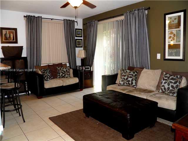 9237 Southwest 227th Street, Unit 12 Cutler Bay, FL 33190 - Photo 9 of 9 a living room with furniture and a window