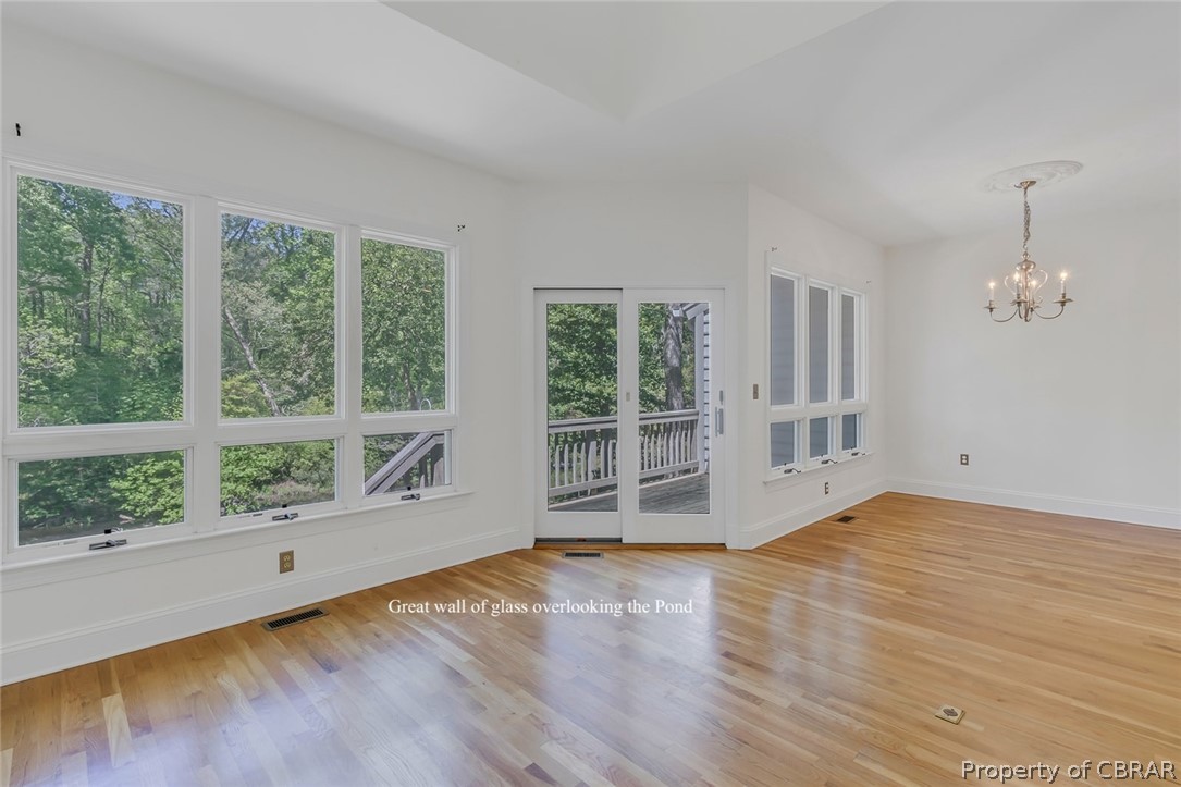 5818 Rivers Landing Terrace, Unit 5818 White Stone, VA 22578 - Photo 13 of 50 Unfurnished room featuring a chandelier and light wood-type flooring