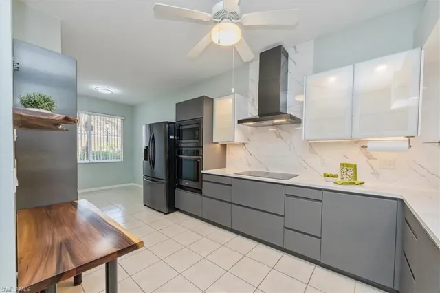 a kitchen with stainless steel appliances kitchen island granite countertop a refrigerator and a sink