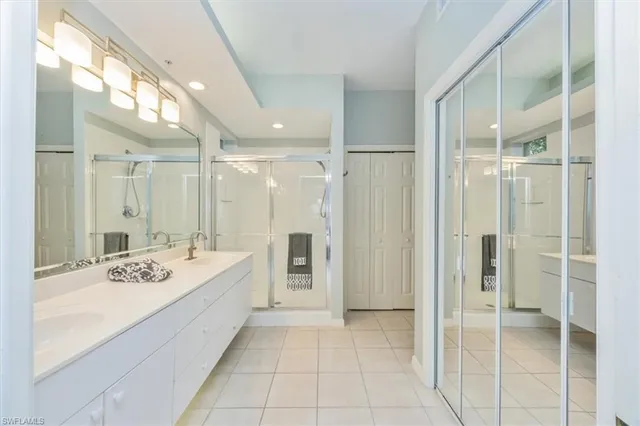 a bathroom with a tub sink shower and mirror