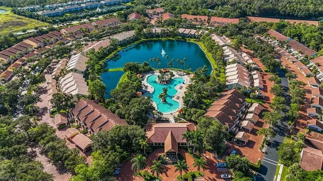 an aerial view of residential houses with outdoor space and swimming pool