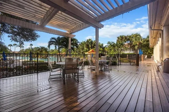 a view of a patio with table and chairs wooden floor and fence