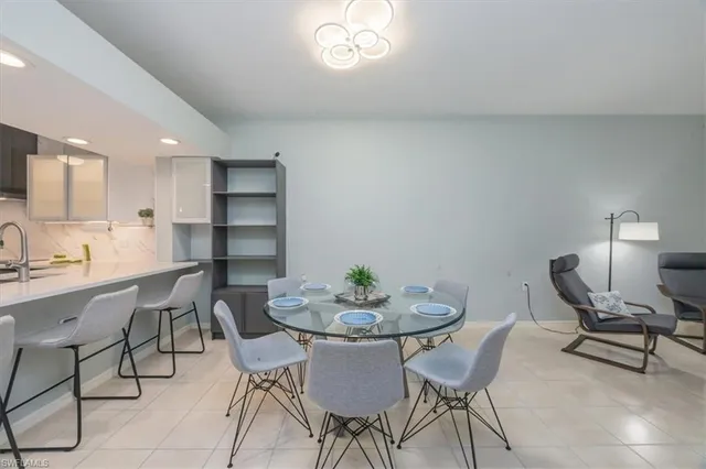 a view of a dining room with furniture and a chandelier