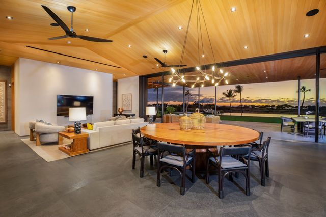 a dining room with a table and chairs